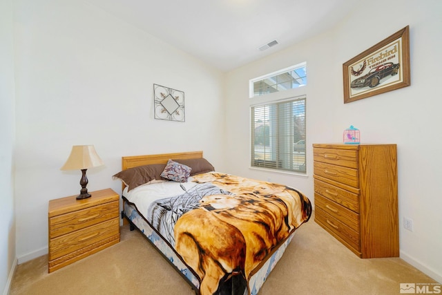 bedroom featuring baseboards, visible vents, and light colored carpet