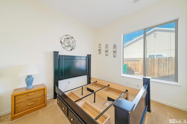 living area with baseboards and light colored carpet