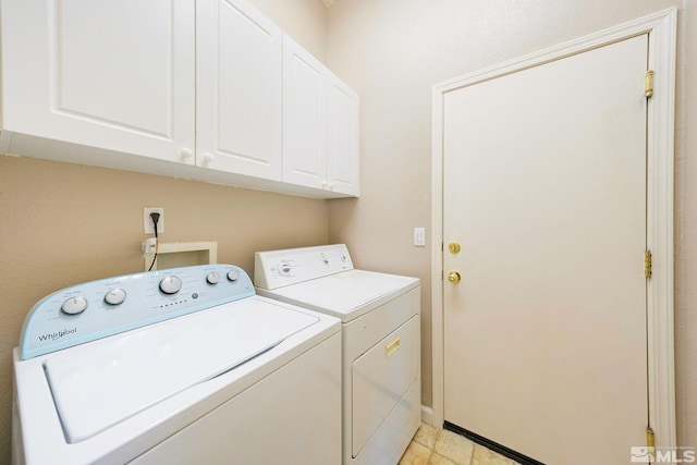 washroom with cabinet space, baseboards, and separate washer and dryer