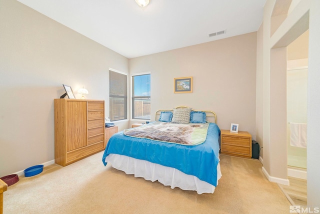 bedroom with baseboards, visible vents, and light colored carpet