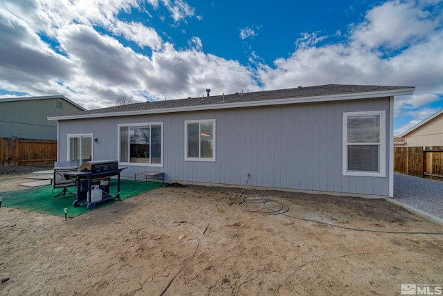 back of property featuring a patio and fence