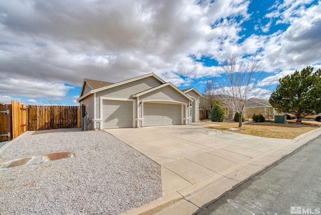 ranch-style house with a garage, concrete driveway, fence, and a front lawn