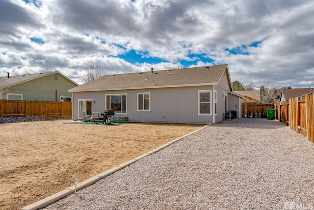 rear view of house with a patio area and a fenced backyard