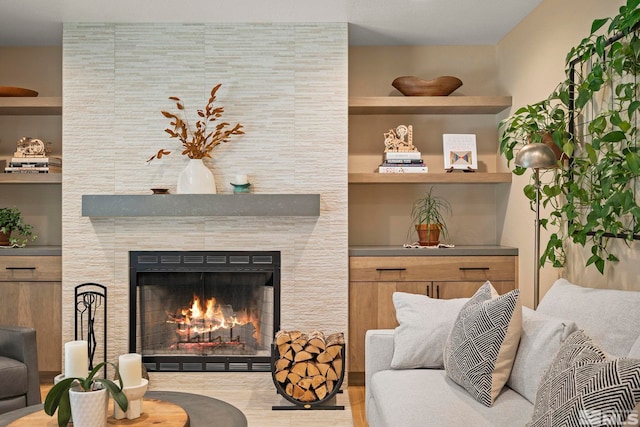 living area featuring a tile fireplace