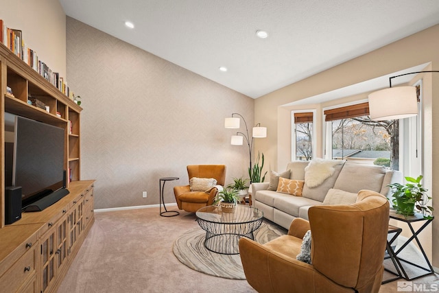 living room with carpet floors, wallpapered walls, baseboards, and lofted ceiling