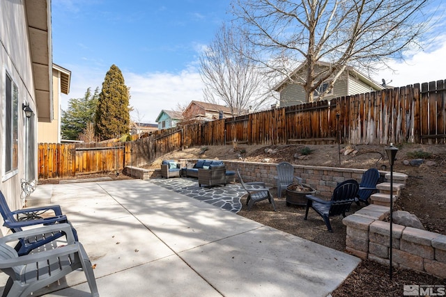 view of patio with an outdoor living space with a fire pit and a fenced backyard