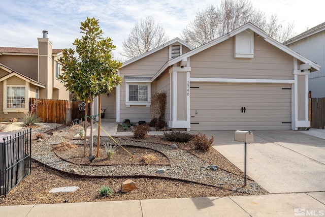 view of front of home with concrete driveway, an attached garage, and fence