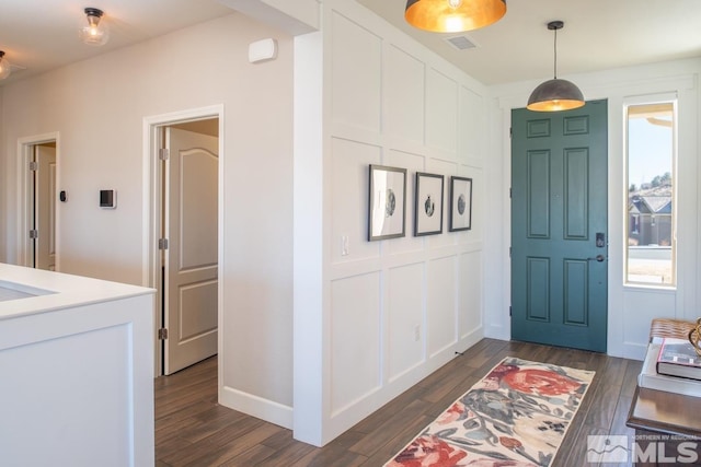 entrance foyer featuring visible vents and dark wood finished floors