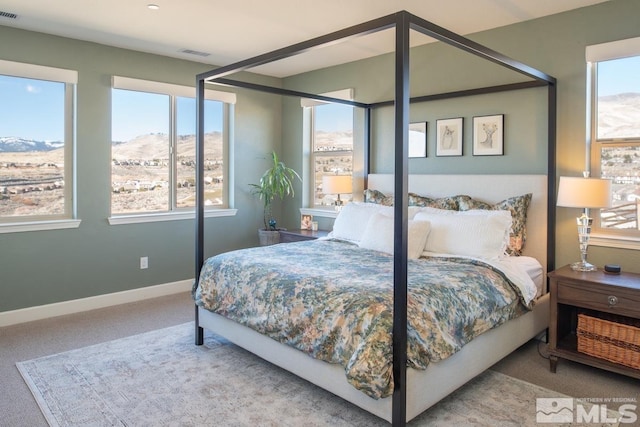 carpeted bedroom featuring visible vents and baseboards