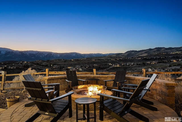 exterior space featuring an outdoor fire pit, a patio area, and a mountain view