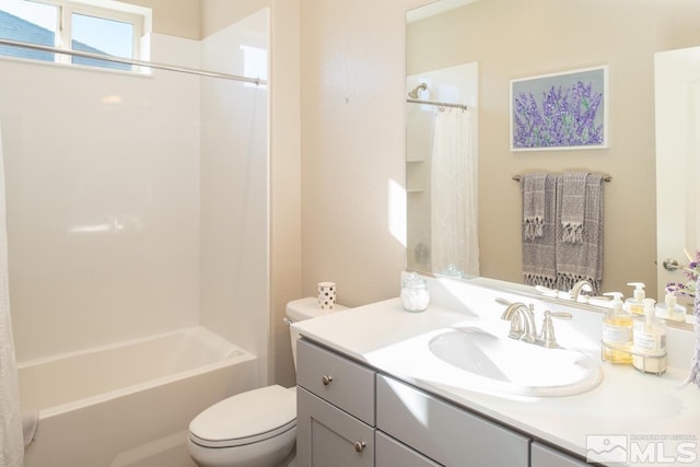 bathroom with shower / bath combination with curtain, vanity, and toilet