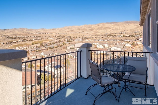 balcony featuring a residential view and a mountain view