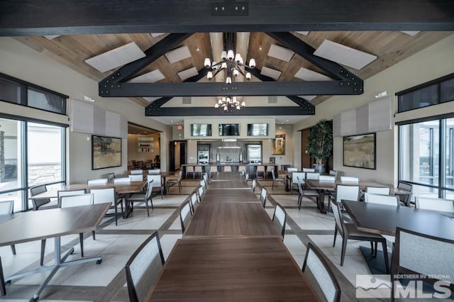 dining room featuring beam ceiling, a notable chandelier, light tile patterned flooring, high vaulted ceiling, and wooden ceiling