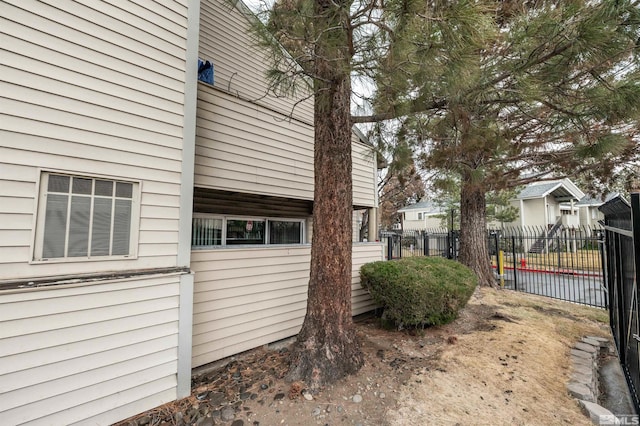 view of side of property featuring fence