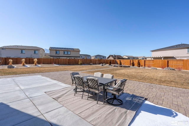 view of patio / terrace with a fenced backyard, a residential view, and outdoor dining area