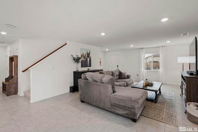 living room with light tile patterned floors, visible vents, stairway, and recessed lighting