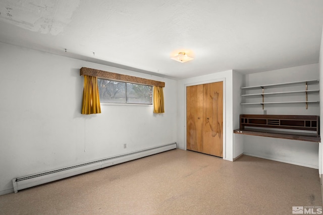 unfurnished bedroom featuring a closet and baseboard heating