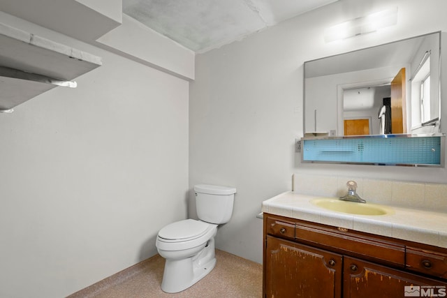 half bathroom with toilet and vanity