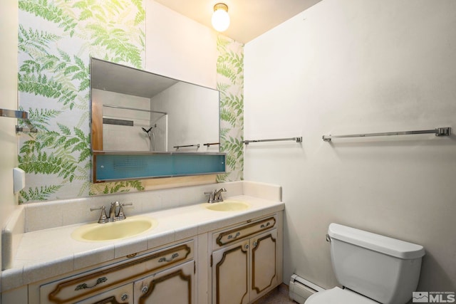 full bathroom featuring double vanity, baseboard heating, a sink, and toilet