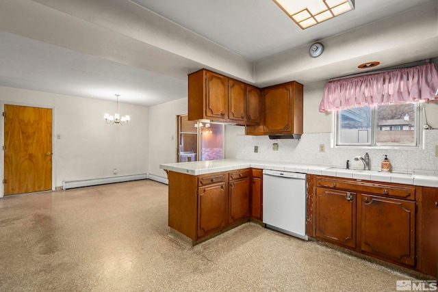 kitchen with a baseboard radiator, brown cabinetry, a chandelier, dishwasher, and a peninsula