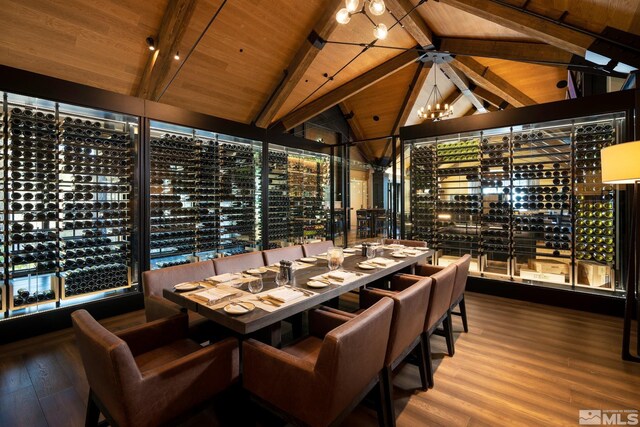 wine area with lofted ceiling with beams, wooden ceiling, wood finished floors, and a notable chandelier