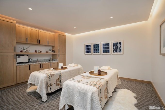 carpeted dining room featuring baseboards