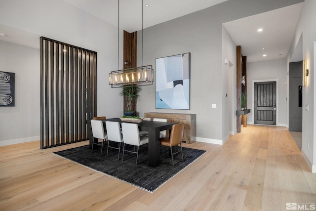 dining area with recessed lighting, wood finished floors, and baseboards