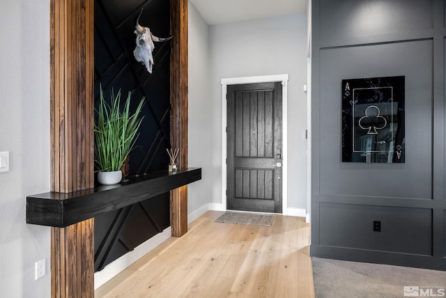 foyer with wood finished floors and baseboards