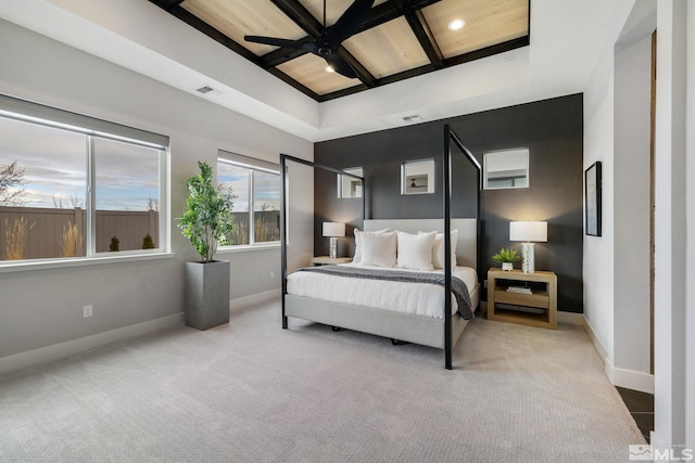 carpeted bedroom with baseboards, visible vents, coffered ceiling, and beamed ceiling