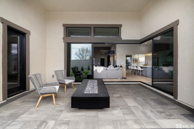 view of patio / terrace with an outdoor living space with a fire pit