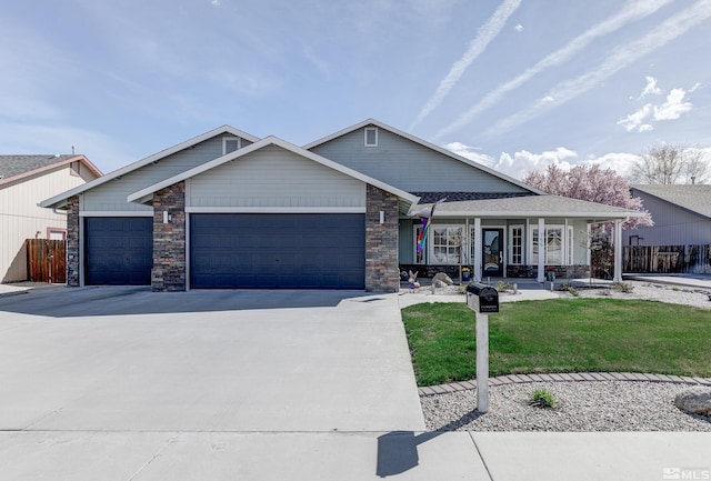 view of front facade featuring covered porch, concrete driveway, a front yard, fence, and a garage