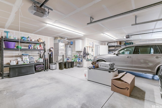 garage featuring strapped water heater and a garage door opener