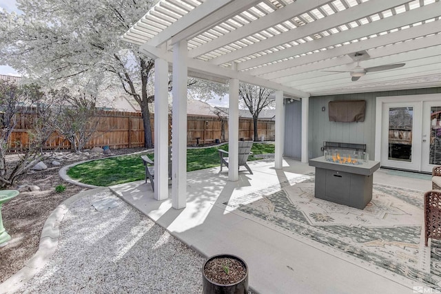 view of patio / terrace with a fire pit, a fenced backyard, a ceiling fan, and a pergola