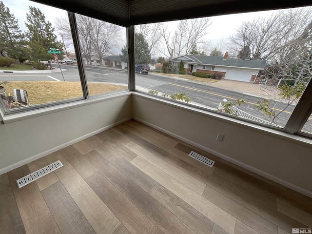 unfurnished sunroom featuring a wealth of natural light and visible vents