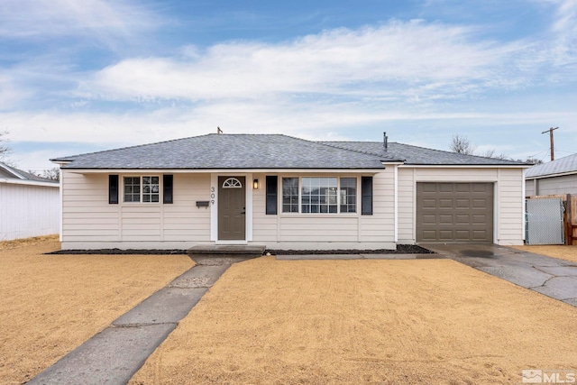 ranch-style home with an attached garage, driveway, fence, and a shingled roof