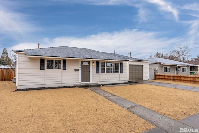 ranch-style house featuring an attached garage, driveway, fence, and roof with shingles