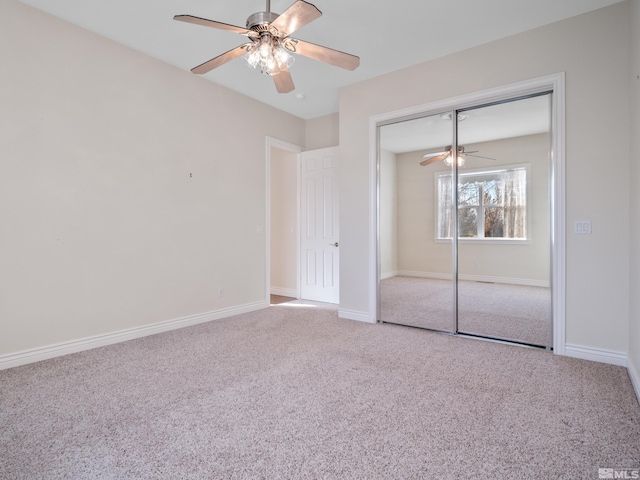 unfurnished bedroom with a ceiling fan, a closet, baseboards, and carpet flooring