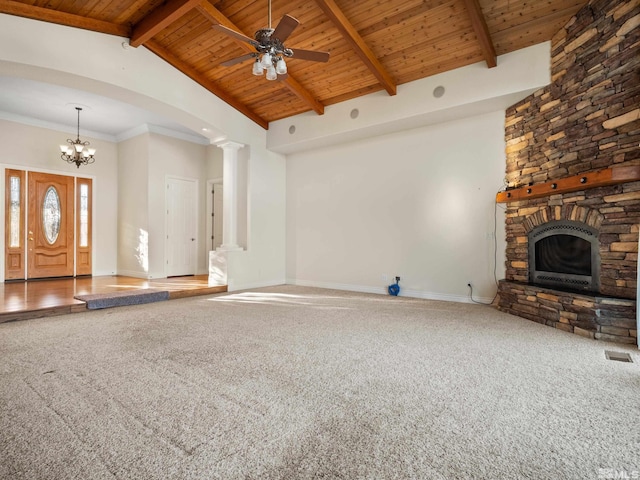 unfurnished living room with carpet floors, beam ceiling, baseboards, and ornate columns