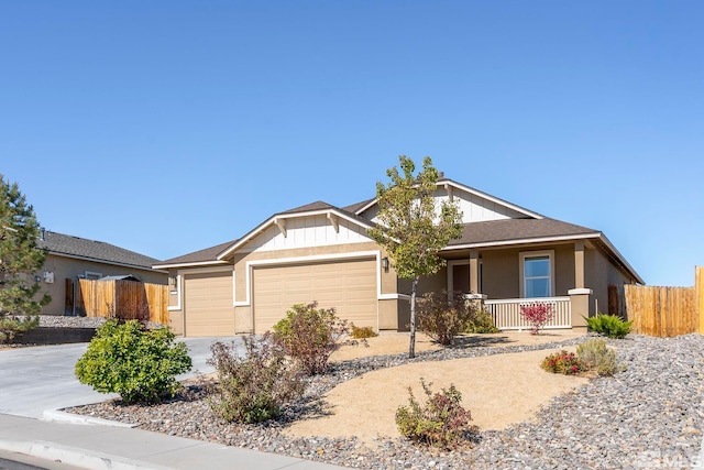 view of front of property featuring an attached garage, driveway, fence, and a porch