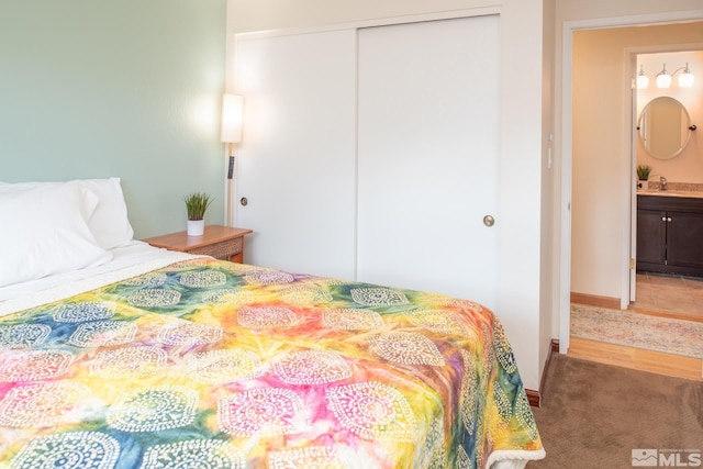 bedroom with a closet and light colored carpet