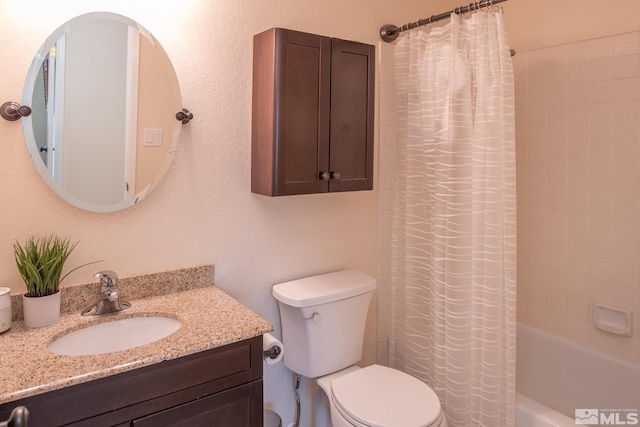 full bath featuring shower / bath combo with shower curtain, vanity, and toilet