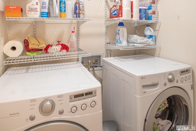 clothes washing area featuring laundry area and washing machine and clothes dryer