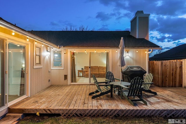 wooden deck featuring fence and area for grilling