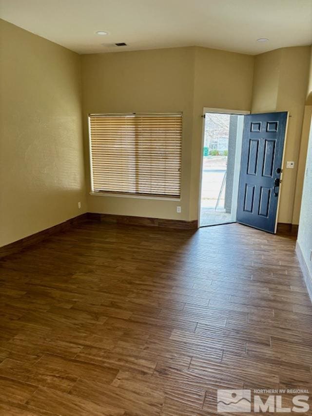 entryway with baseboards and wood finished floors