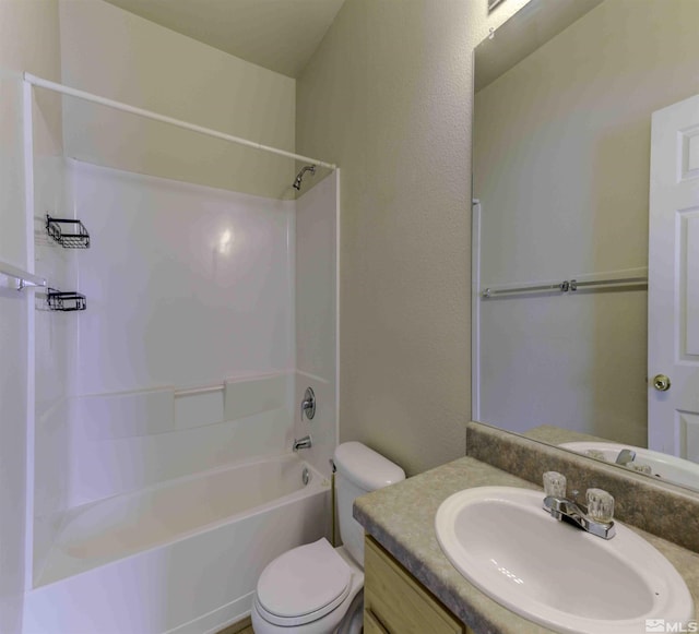 bathroom featuring washtub / shower combination, vanity, and toilet