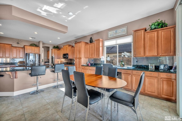 dining area with baseboards, light tile patterned flooring, and recessed lighting