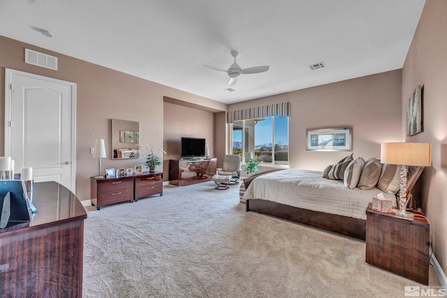 carpeted bedroom with baseboards, visible vents, and a ceiling fan