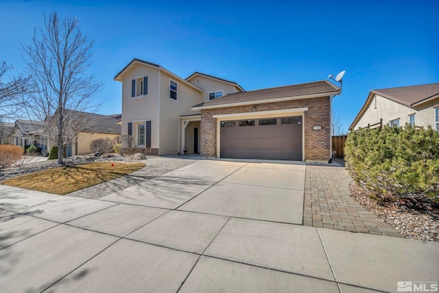 traditional-style home with brick siding, driveway, and an attached garage