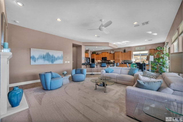 living area with baseboards, visible vents, a ceiling fan, and recessed lighting