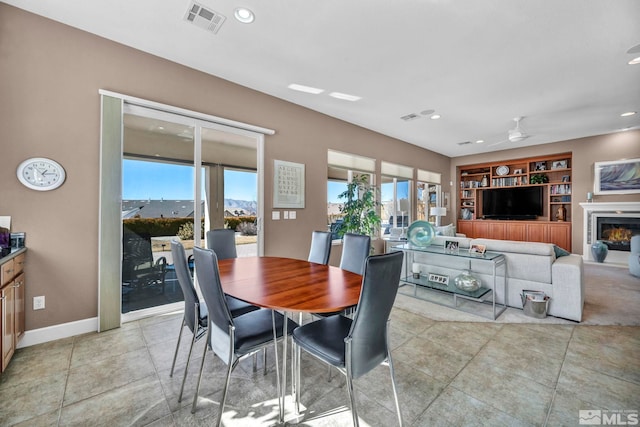 dining space with built in features, recessed lighting, visible vents, a ceiling fan, and baseboards